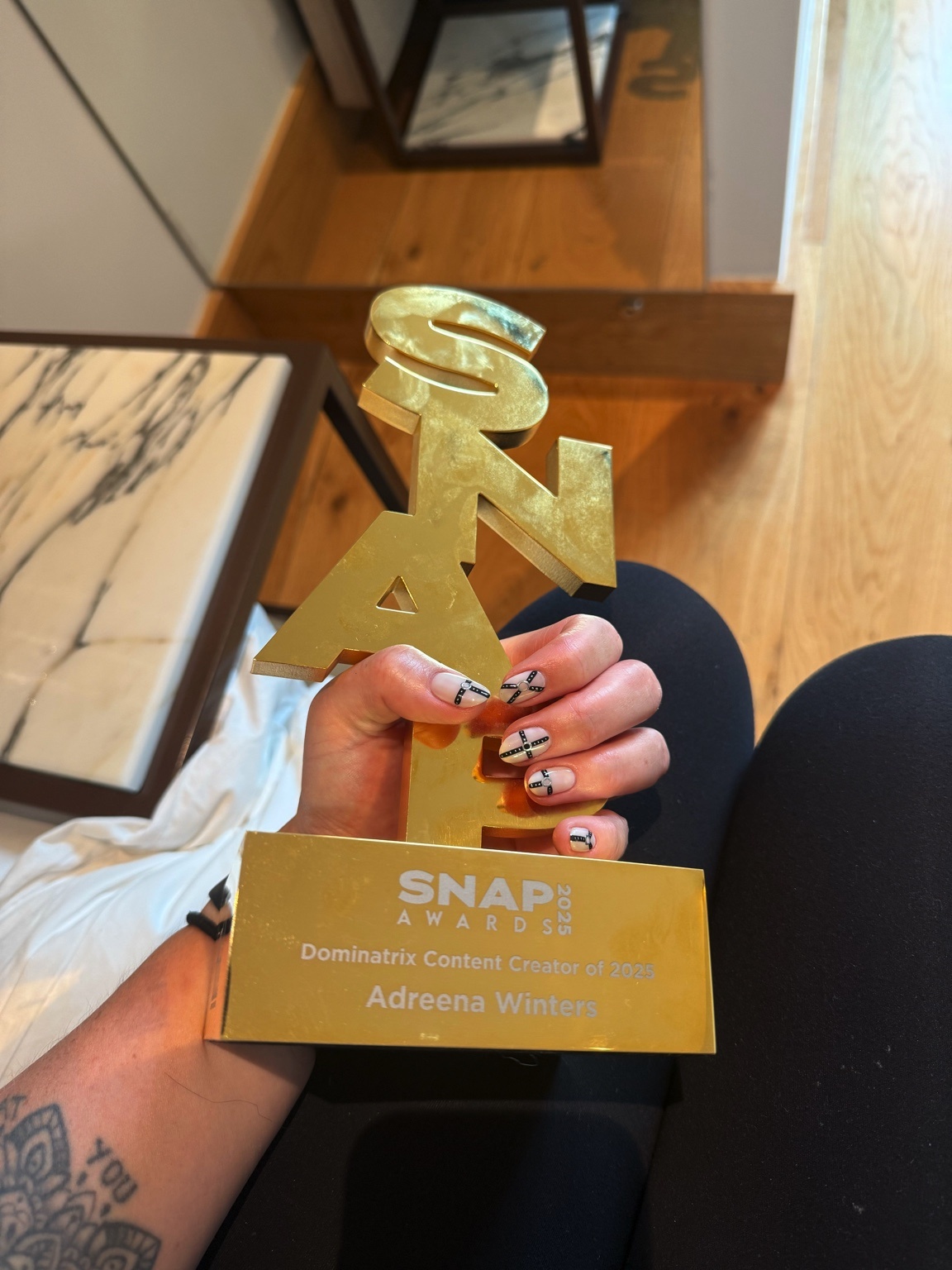 Adreena Winters holding an award